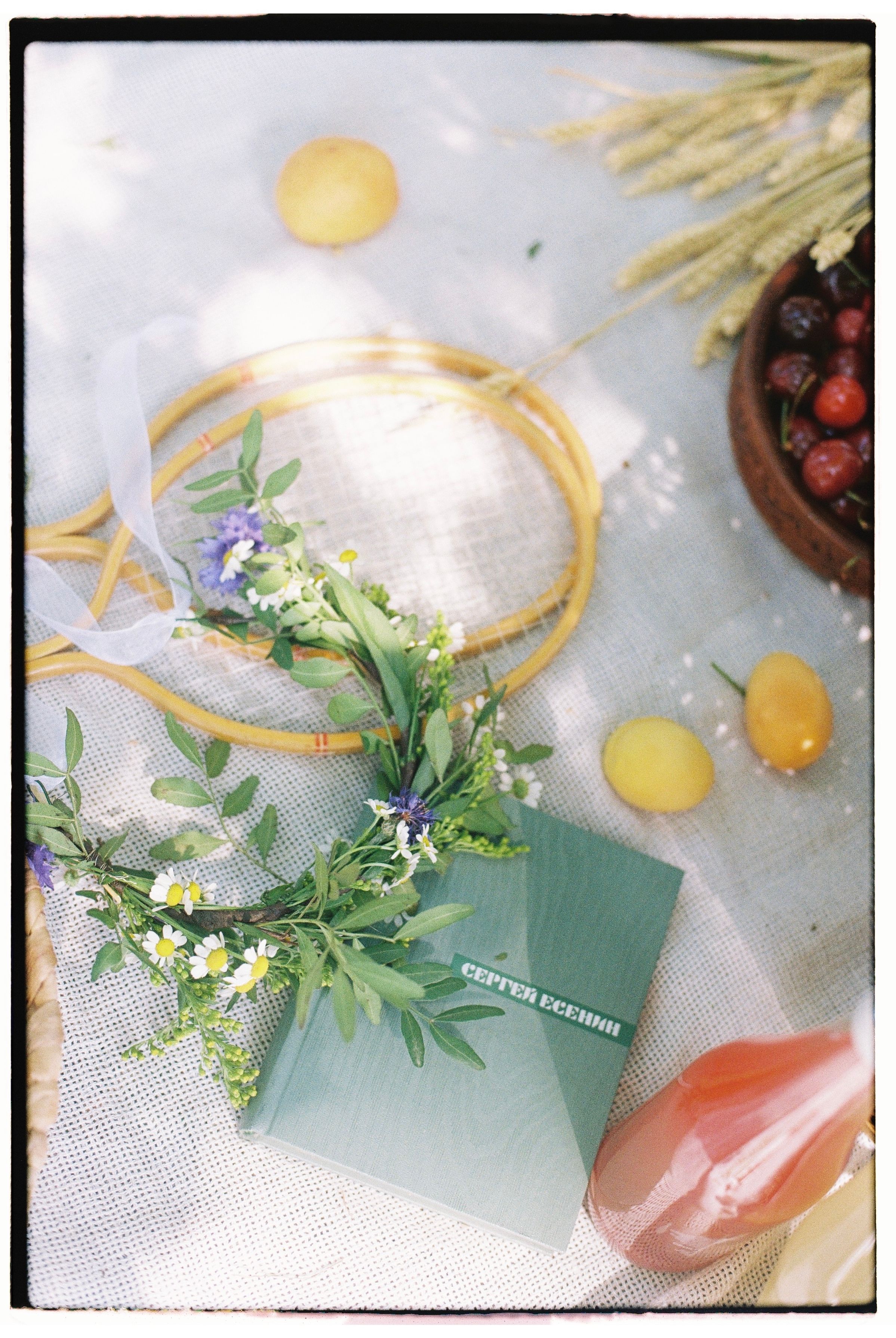 Charming summer picnic setup with fresh fruits and wildflowers.