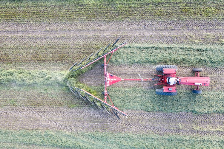 Farmer Driving Tractor Pulling Hay Rake Machine