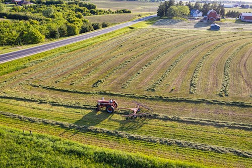 Drone Shot of a Person Using a Tractor on a Field