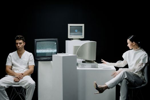 A modern depiction with vintage computers and individuals in a futuristic lab setting.
