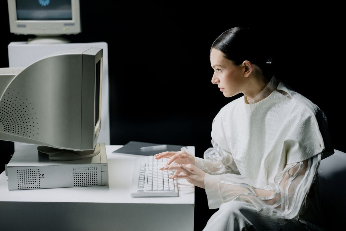 Woman in White Dress Shirt Using a Computer · Free Stock Photo