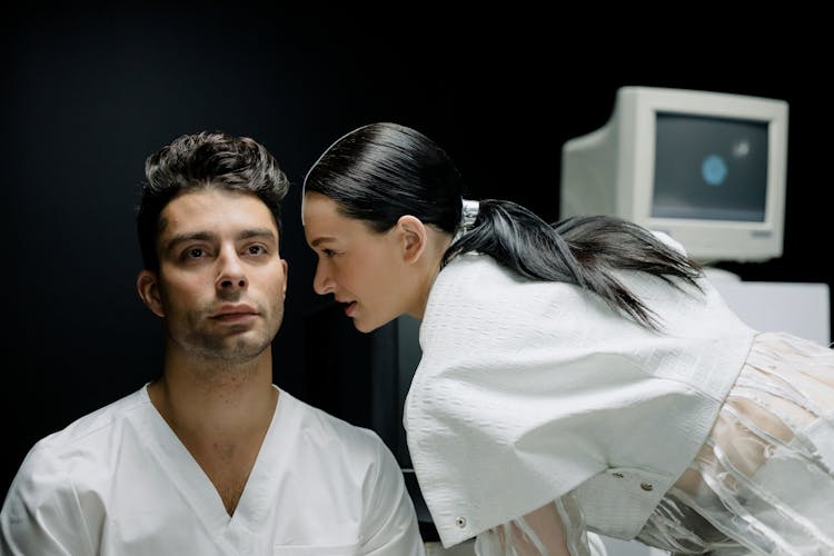 Woman Talking To A Man In White Top