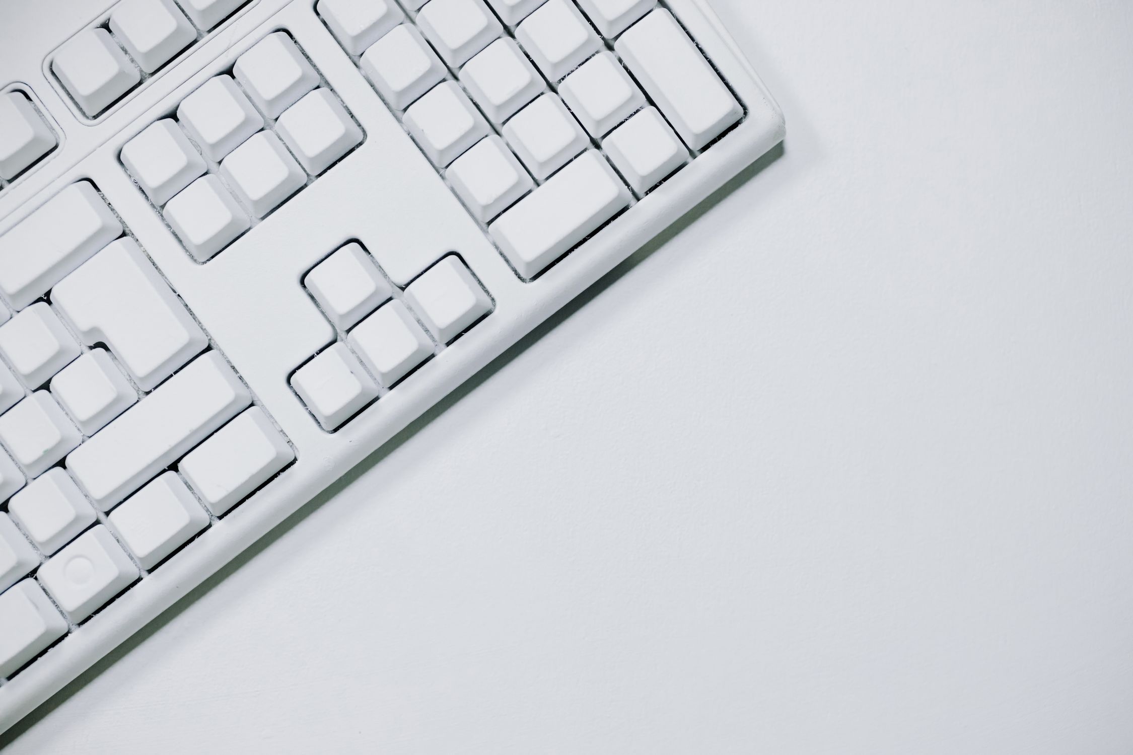 White Computer Keyboard on White Table · Free Stock Photo