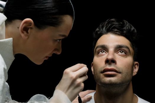 Close-up of a medical professional conducting an eye check on a patient indoors.