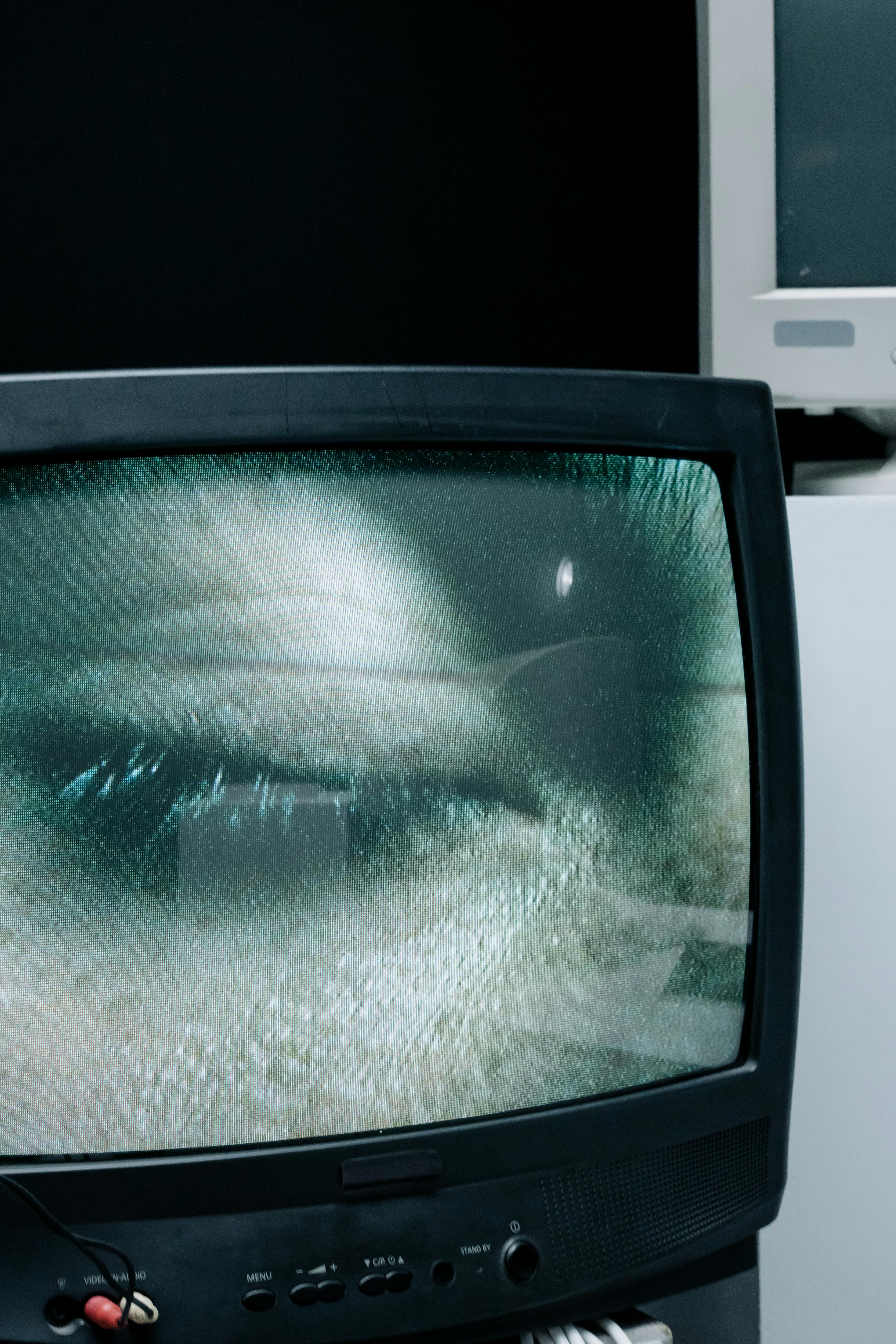 person s eye showing on television screen