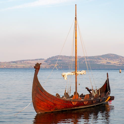 Brown Wooden Boat on Sea