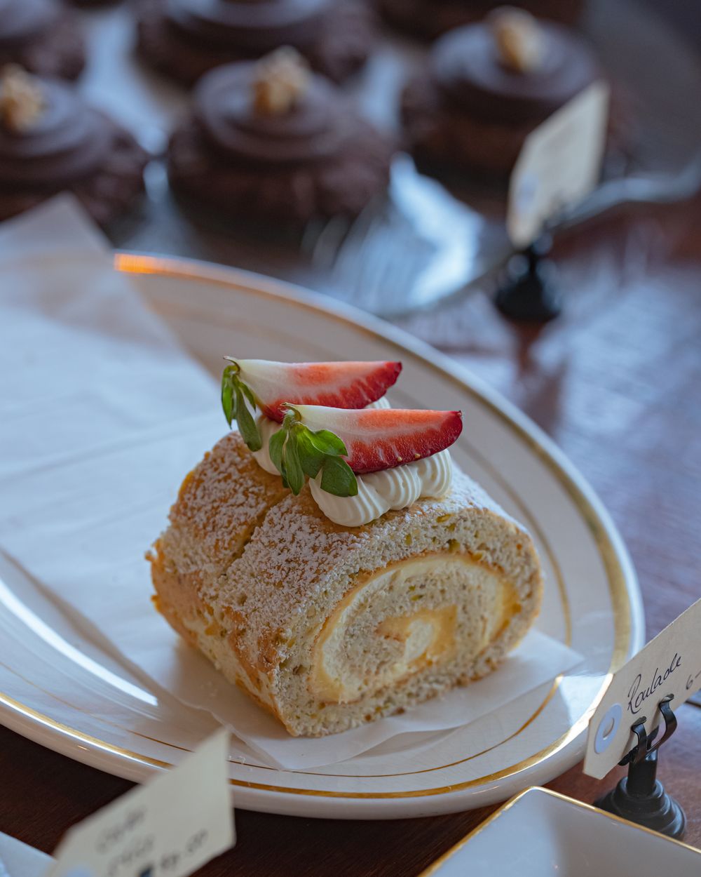 A layered cake topped with fresh strawberries