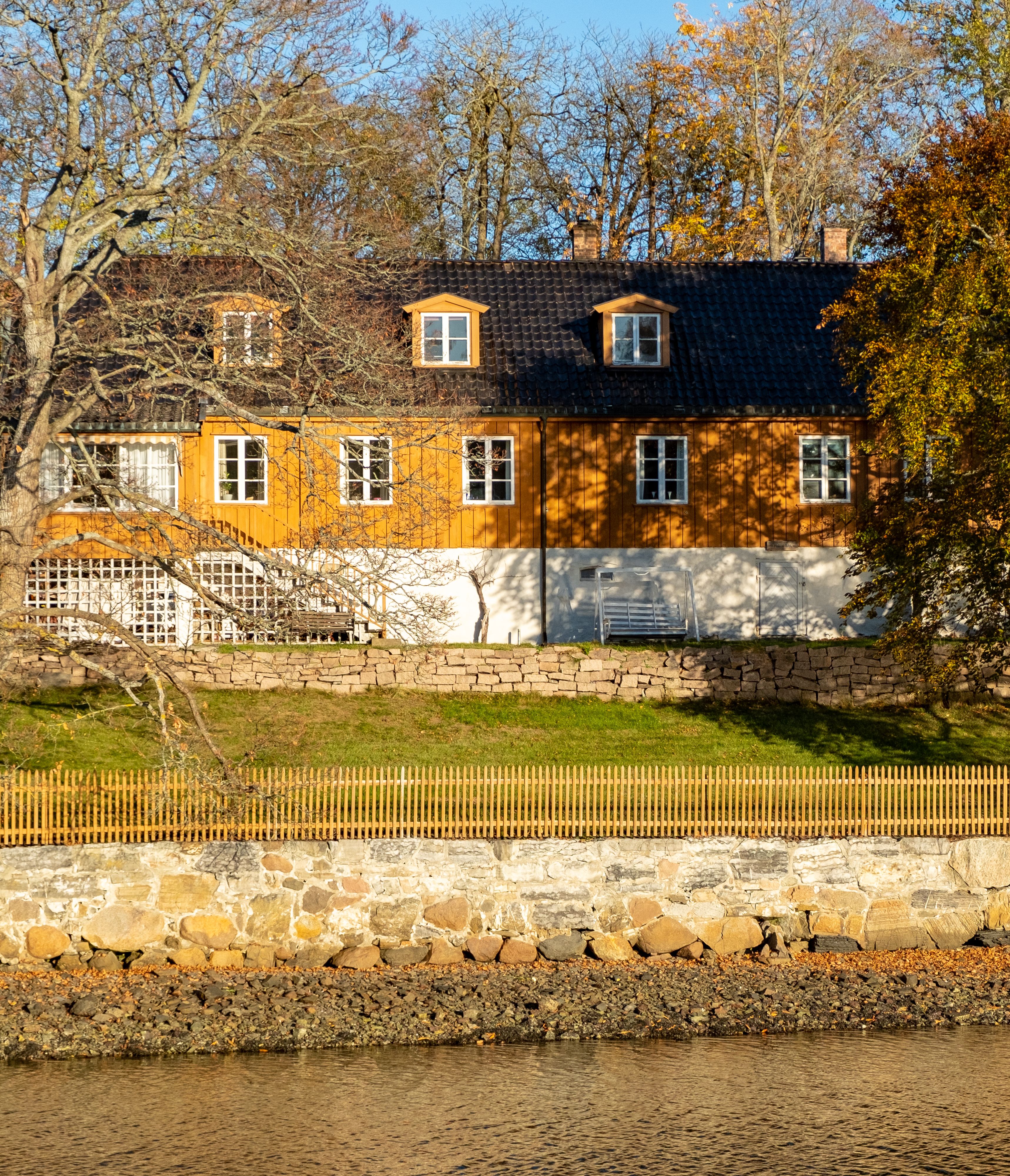 A Brown and White Wooden House Near River · Free Stock Photo
