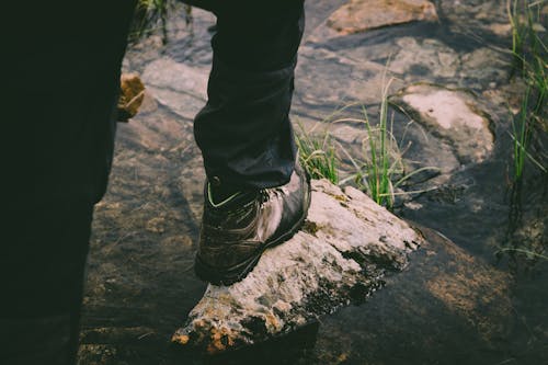 Free A Person Stepping on a Rock  Stock Photo