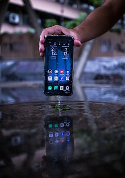 A smartphone held over water creates a mirror effect, showcasing its waterproof ability.