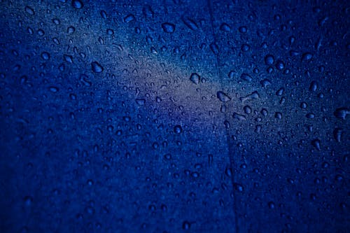 Macro Shot of Water Droplets on a Blue Surface