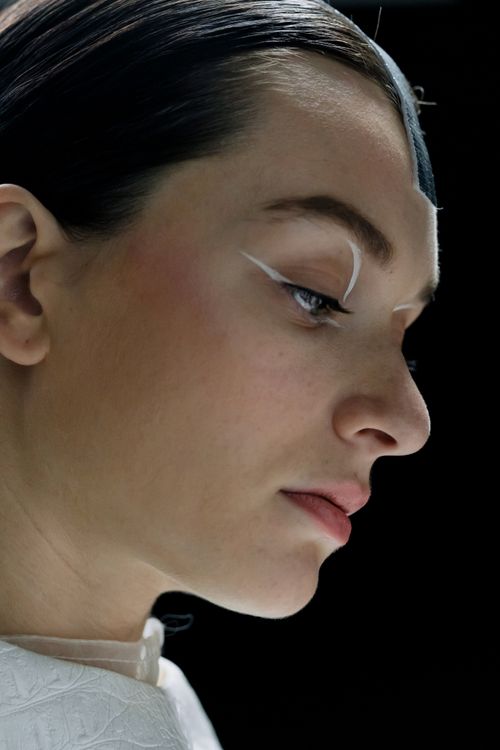 Free Close-up side view of a woman with futuristic makeup against a black background. Stock Photo