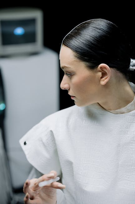 A woman in sleek white futuristic attire captured in a modern lab setting.