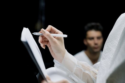 Person Holding a Pen and Notebook
