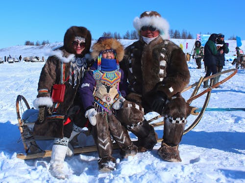 Photograph of a Family Sitting on a Sled