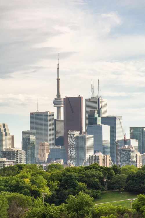 Free Stunning view of Toronto's skyline with the iconic CN Tower and lush greenery. Stock Photo