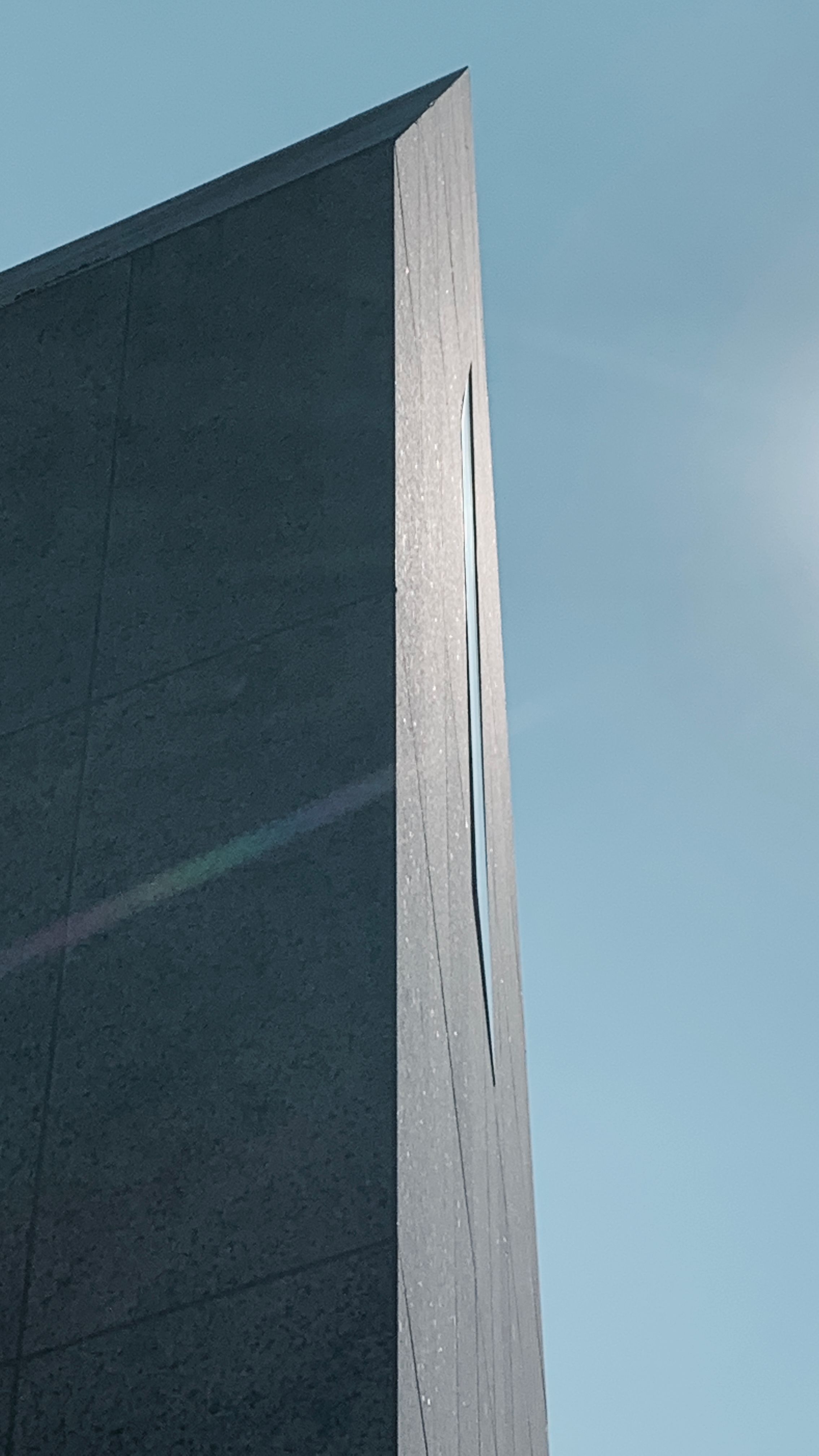 Minimalist architecture captured with a sleek facade and clear blue sky in Recklinghausen, Germany.