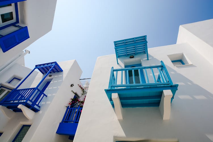 White Painted House With Blue And Teal Terrace