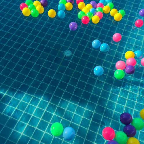 бесплатная Разноцветные шарики, плавающие на воде Стоковое фото