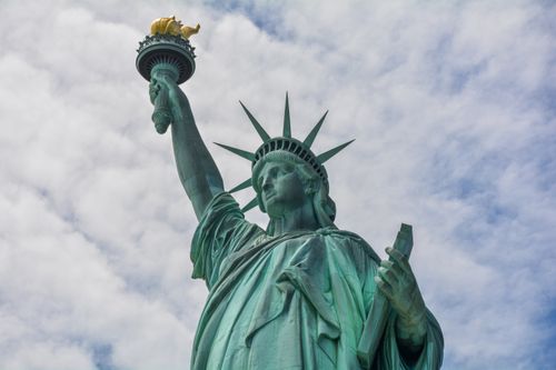 Free Low angle view of the Statue of Liberty with dramatic clouds in New York City. Stock Photo