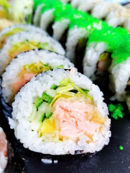 Vibrant sushi rolls showcasing tuna, vegetables, and seaweed in a close-up shot.