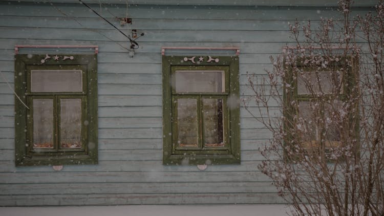 Snow Falling Outside A House