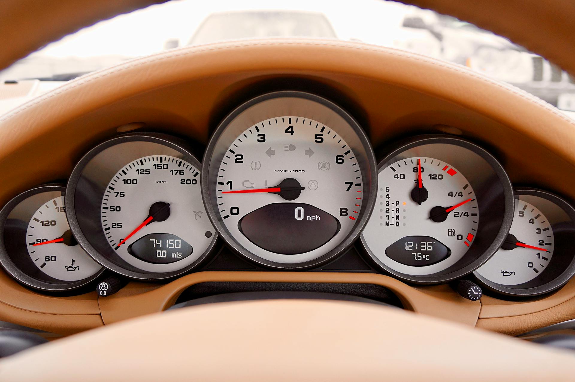 Detailed view of car dashboard displaying speedometer, odometer, and other gauges.