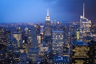 纽约市的天际线在夜间展现出令人惊叹的景观，摩天大楼被灯光照亮