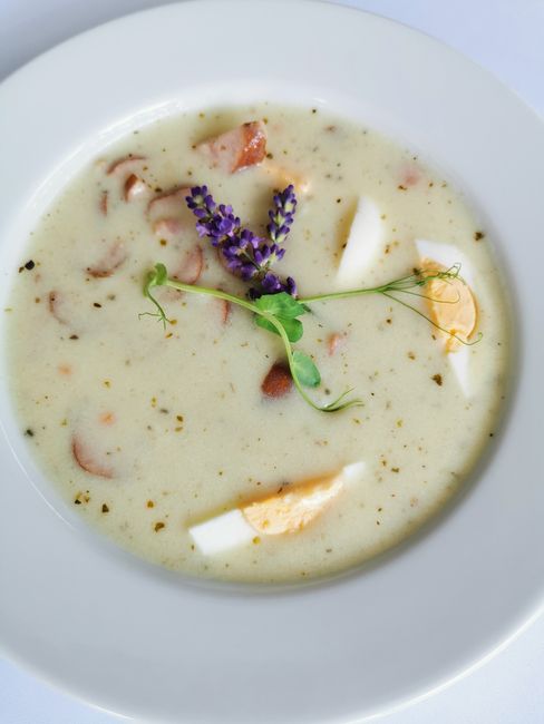 A traditional Polish sour rye soup made with fermented rye starter, smoked sausage, and a soft-boiled egg.