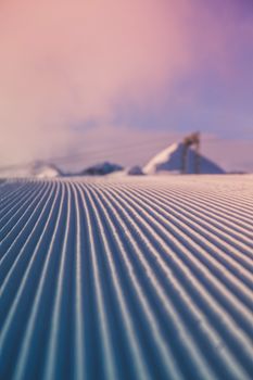 Vibrant pink sky over tranquil snow-covered ridges. Scenic winter landscape, perfect for travel inspiration.