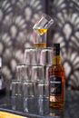 A Bottle of Scotch and Stacked Glasses