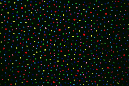 Vibrant abstract art with colorful dots scattered across a black background
