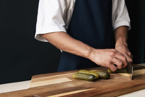 Free Person Cutting a Cucumber Stock Photo