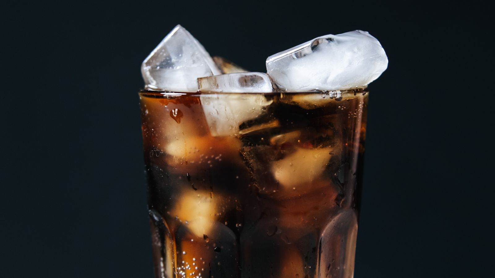 A refreshing glass of cola with ice cubes — photo by Ron Lach on Pexels A refreshing glass of cola with ice cubes