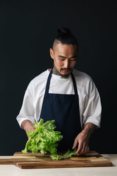 A Male Chef Holding Fresh Lettuce