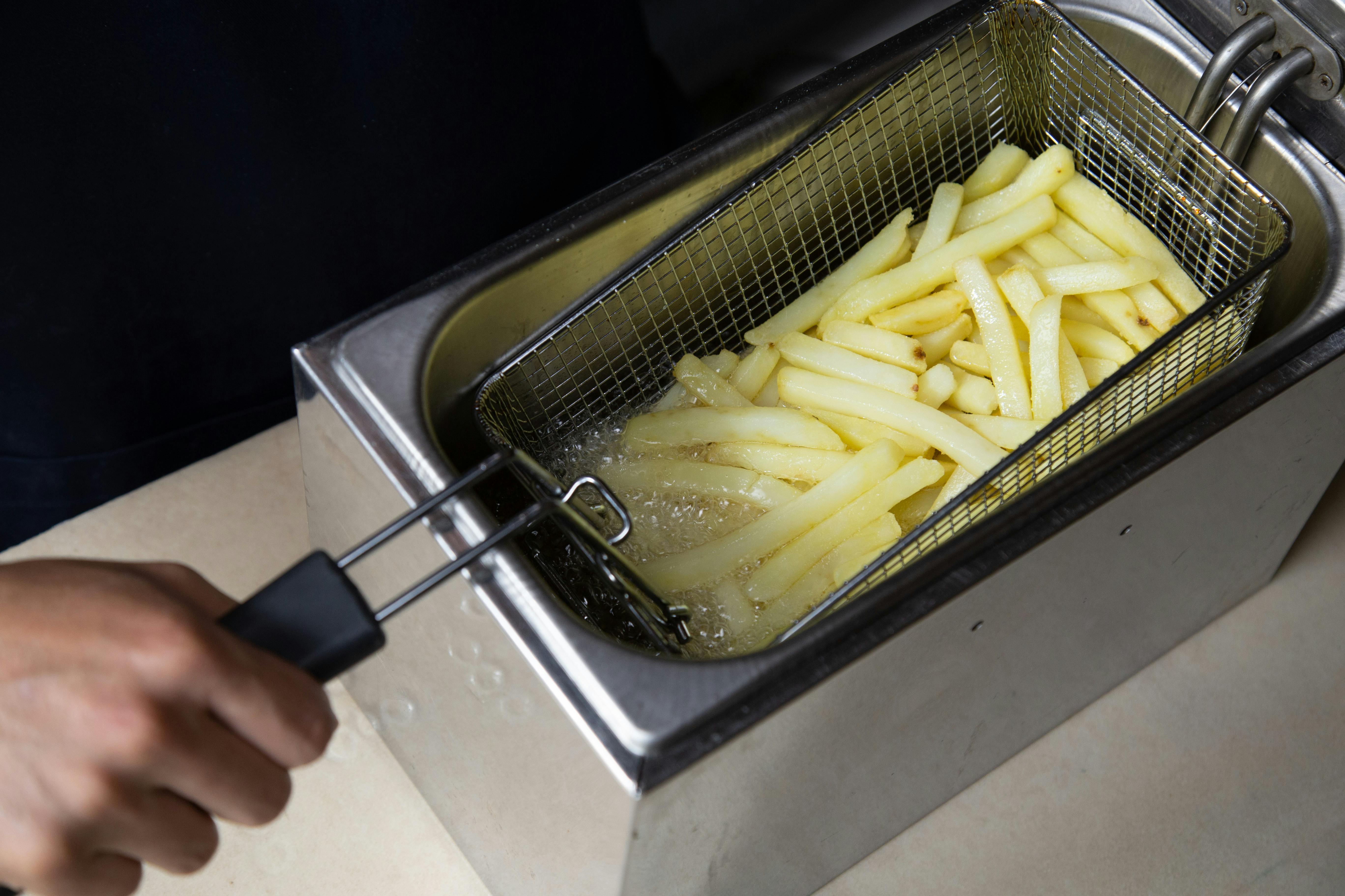 Friing Potatos In Fryier For French Fries Stock Photo - Download Image Now  - French Fries, Fried, Deep-fryer - iStock