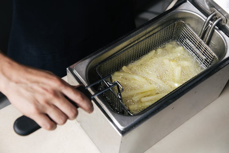 A Person Cooking French Fries