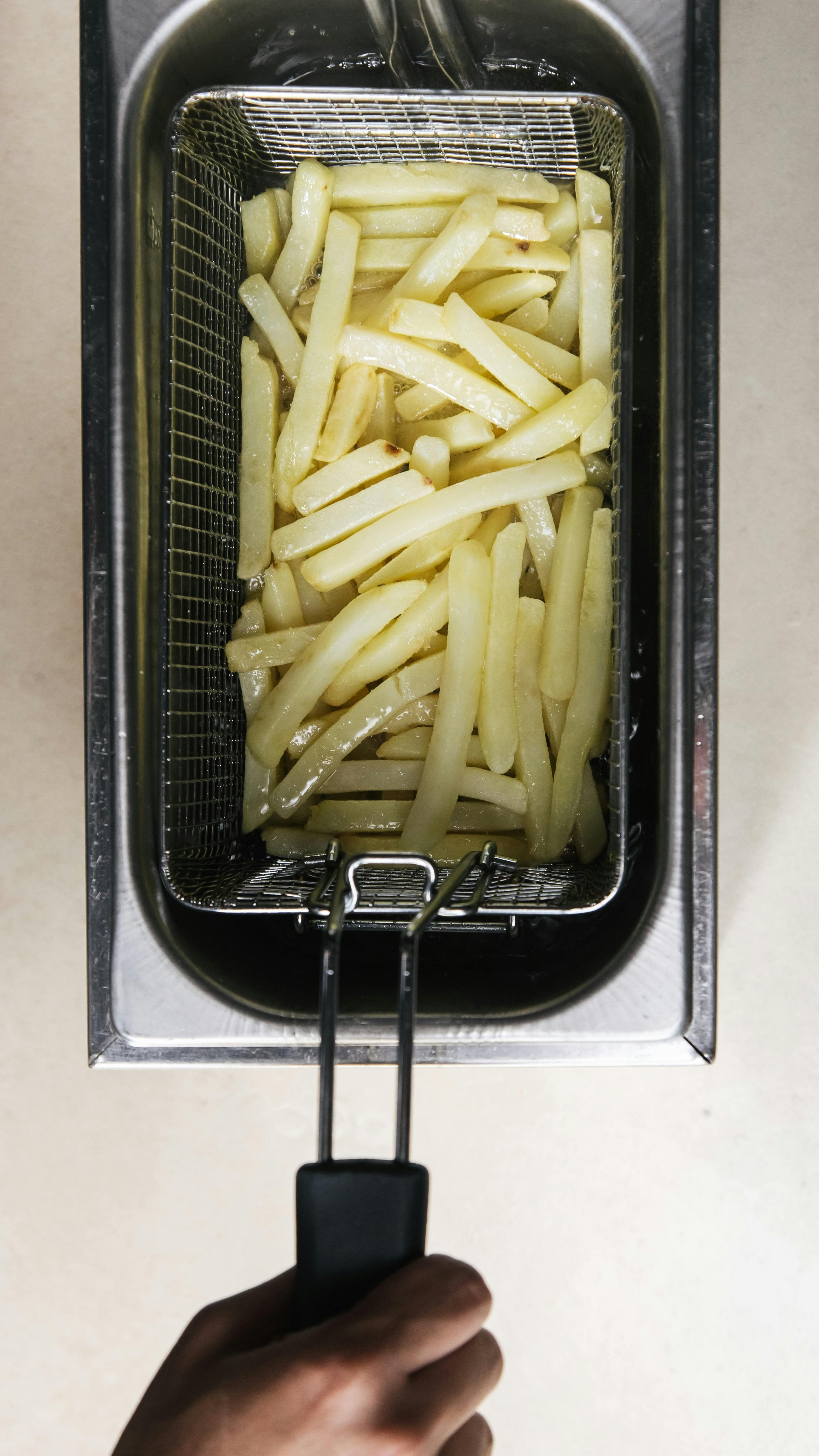 Friing Potatos In Fryier For French Fries Stock Photo - Download Image Now  - French Fries, Fried, Deep-fryer - iStock