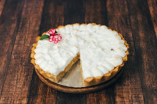 Free Close-up of a delicious creamy pie with flower decoration on wood. Stock Photo
