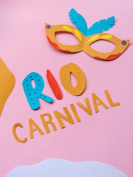 Vibrant paper cutouts featuring a mask and 'Rio Carnival' text on pastel background.