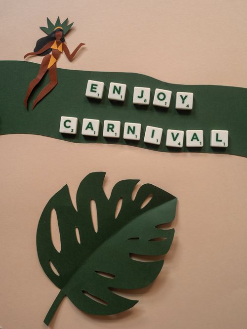 Free Vibrant paper art with 'Enjoy Carnival' spelled out using letter tiles on a festive background. Stock Photo