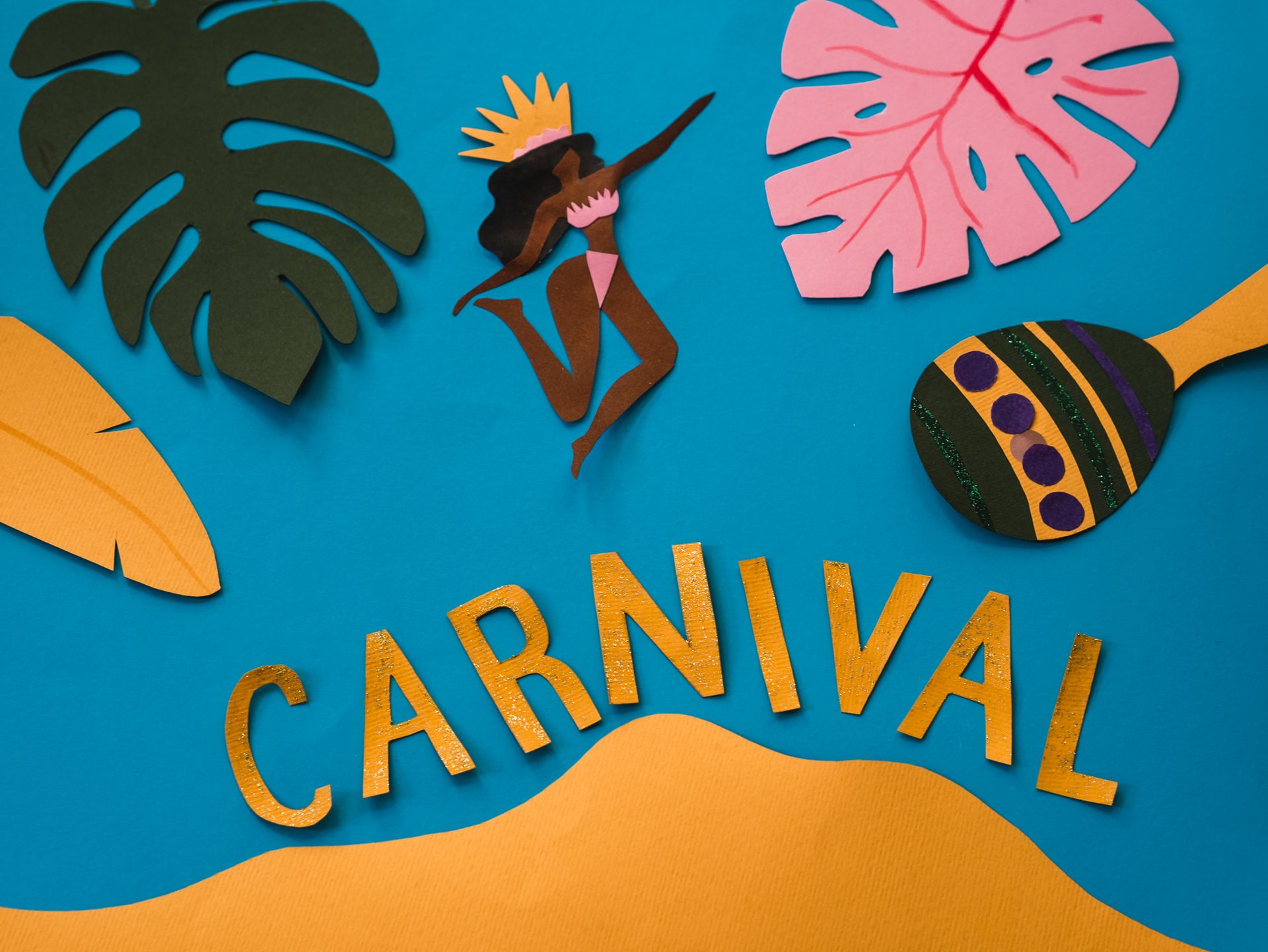 Colorful paper cutout design of carnival theme with tropical leaves and dancer.