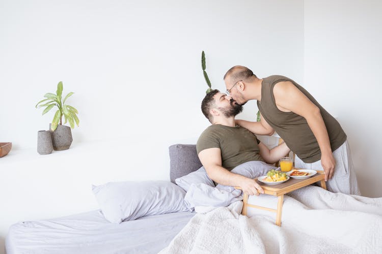 Couple Kissing On Bed