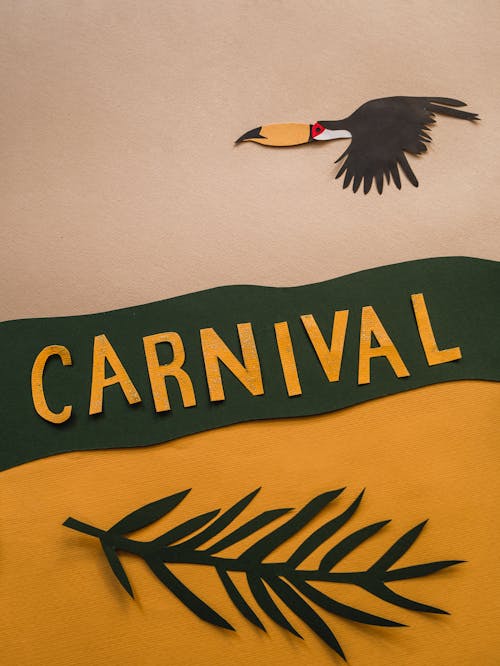 Photo of a Paper Bird Near the Word Carnival