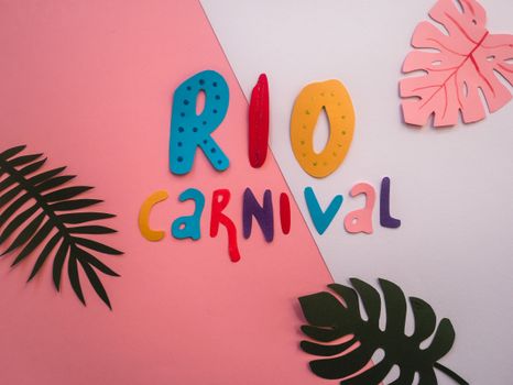Vibrant and colorful paper cutout letters spelling 'Rio Carnival' with tropical leaf designs.