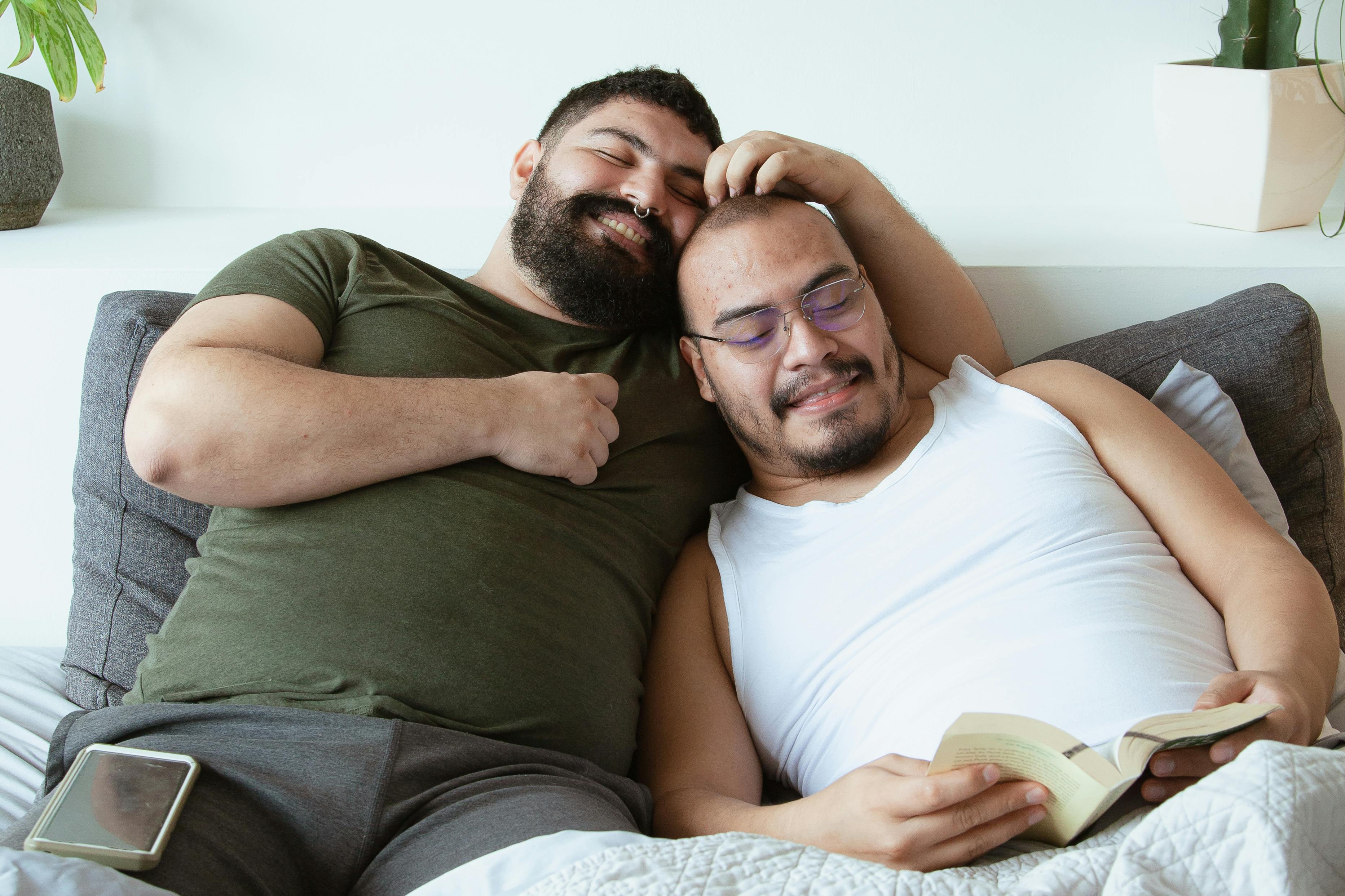 happy couple sitting on the bed