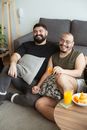 Happy Men Sitting on the Floor
