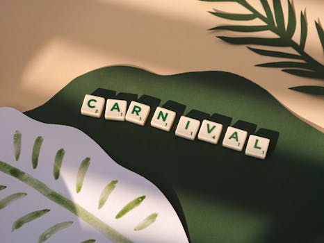 Festive carnival scene with Scrabble tiles spelling 'CARNIVAL', decorated with green leaves.