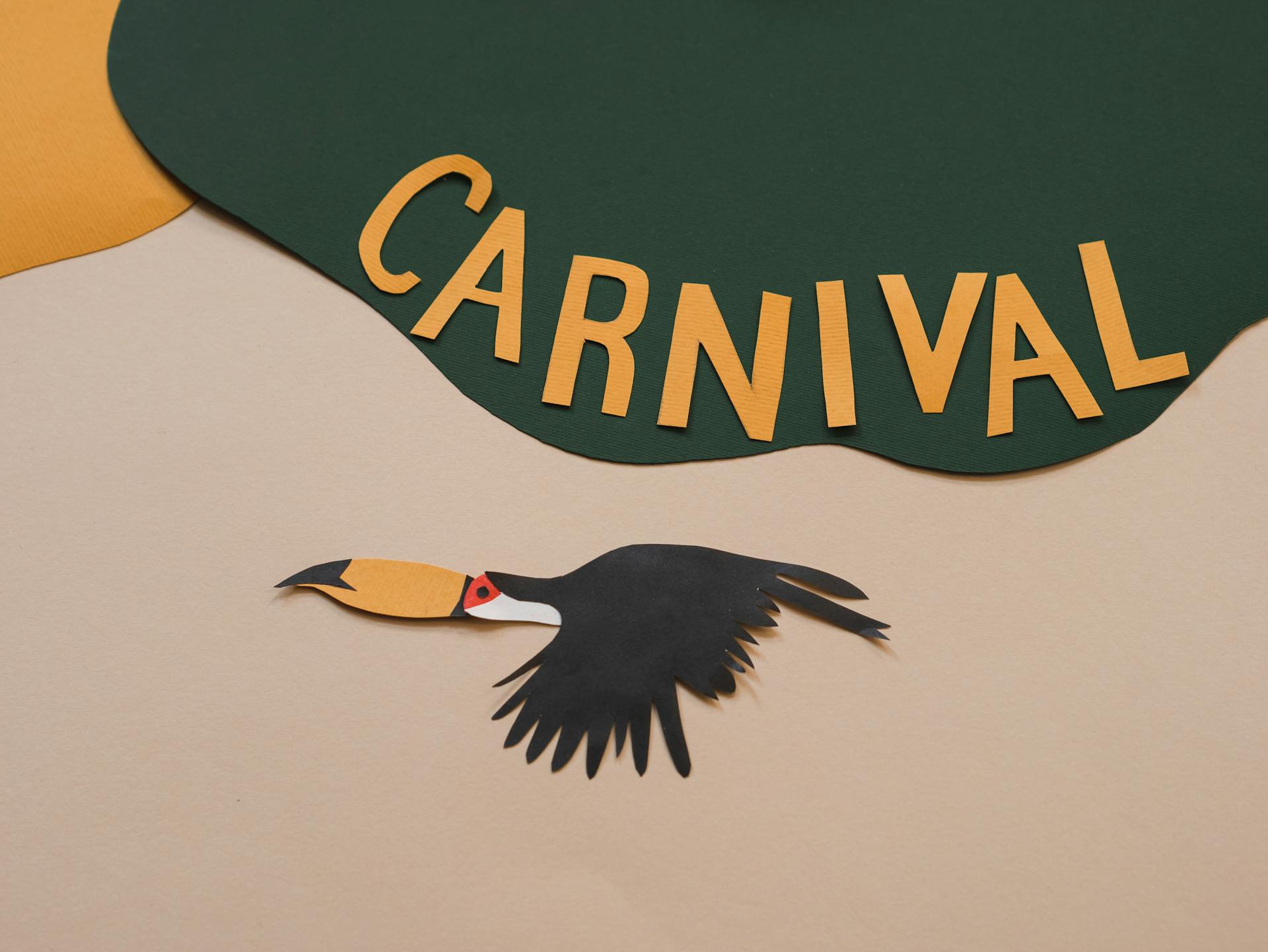 Photo of a Paper Bird Under the Word Carnival