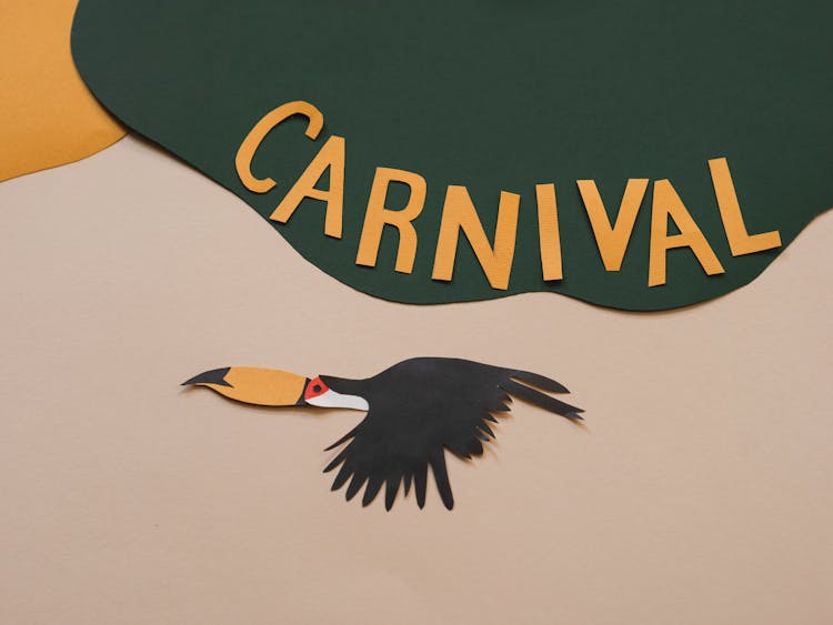 Photo Of A Paper Bird Under The Word Carnival